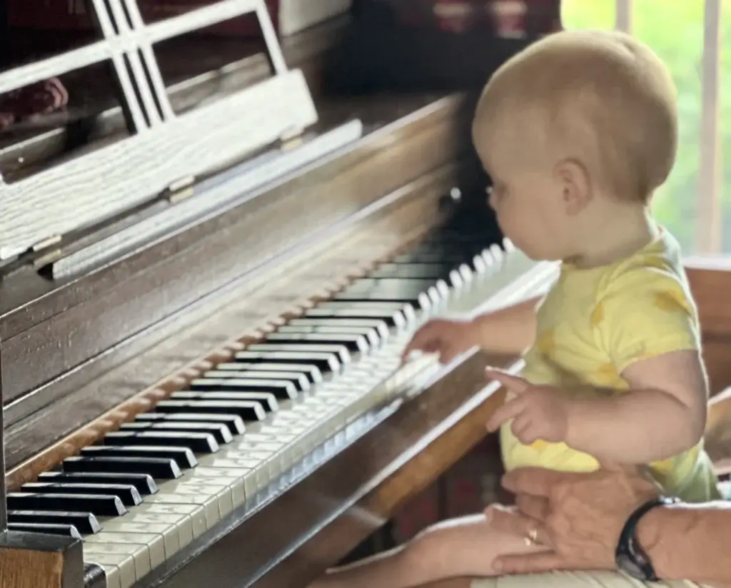 A future piano player on Mom's lap.